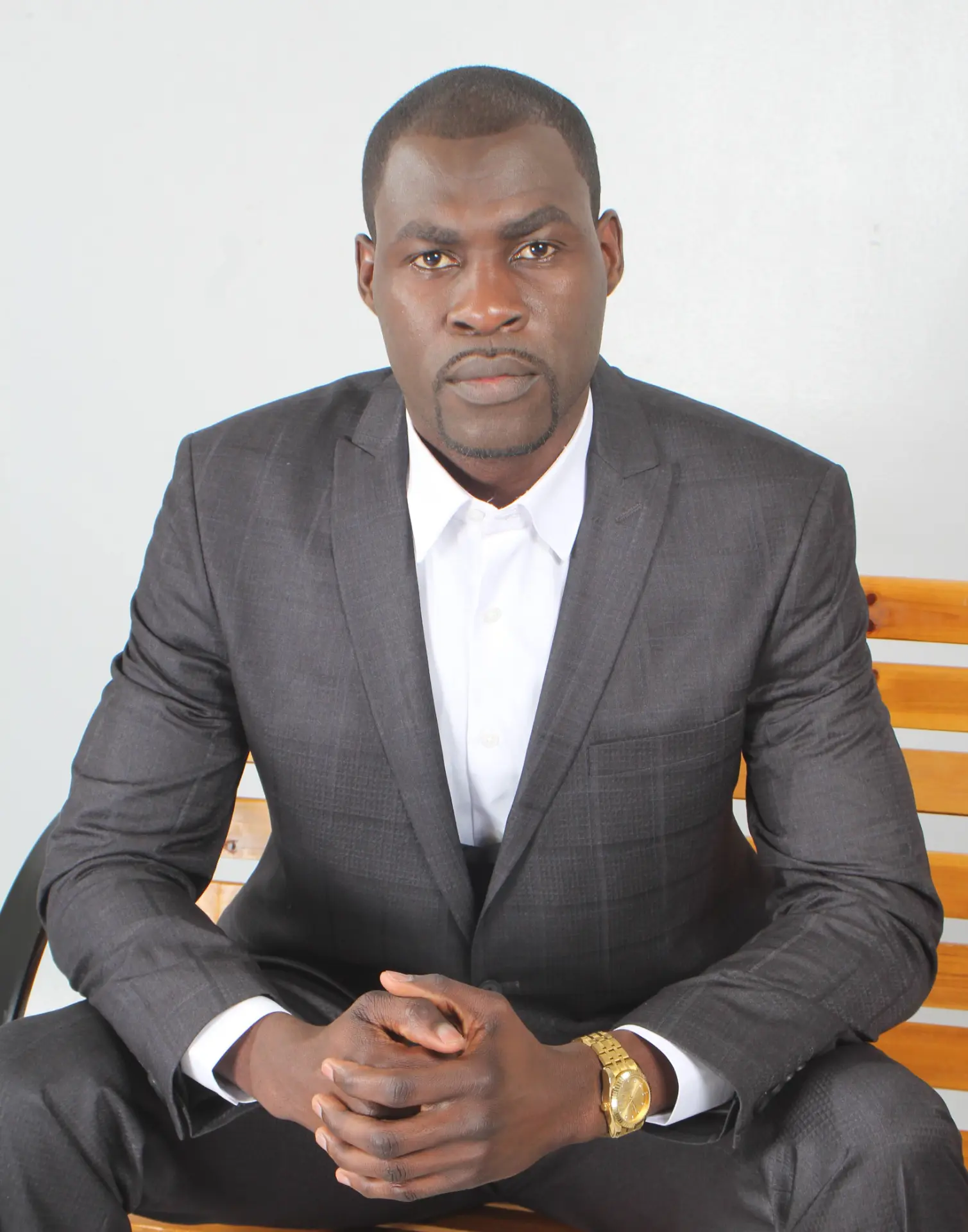Daniel Cole seated in a grey suit