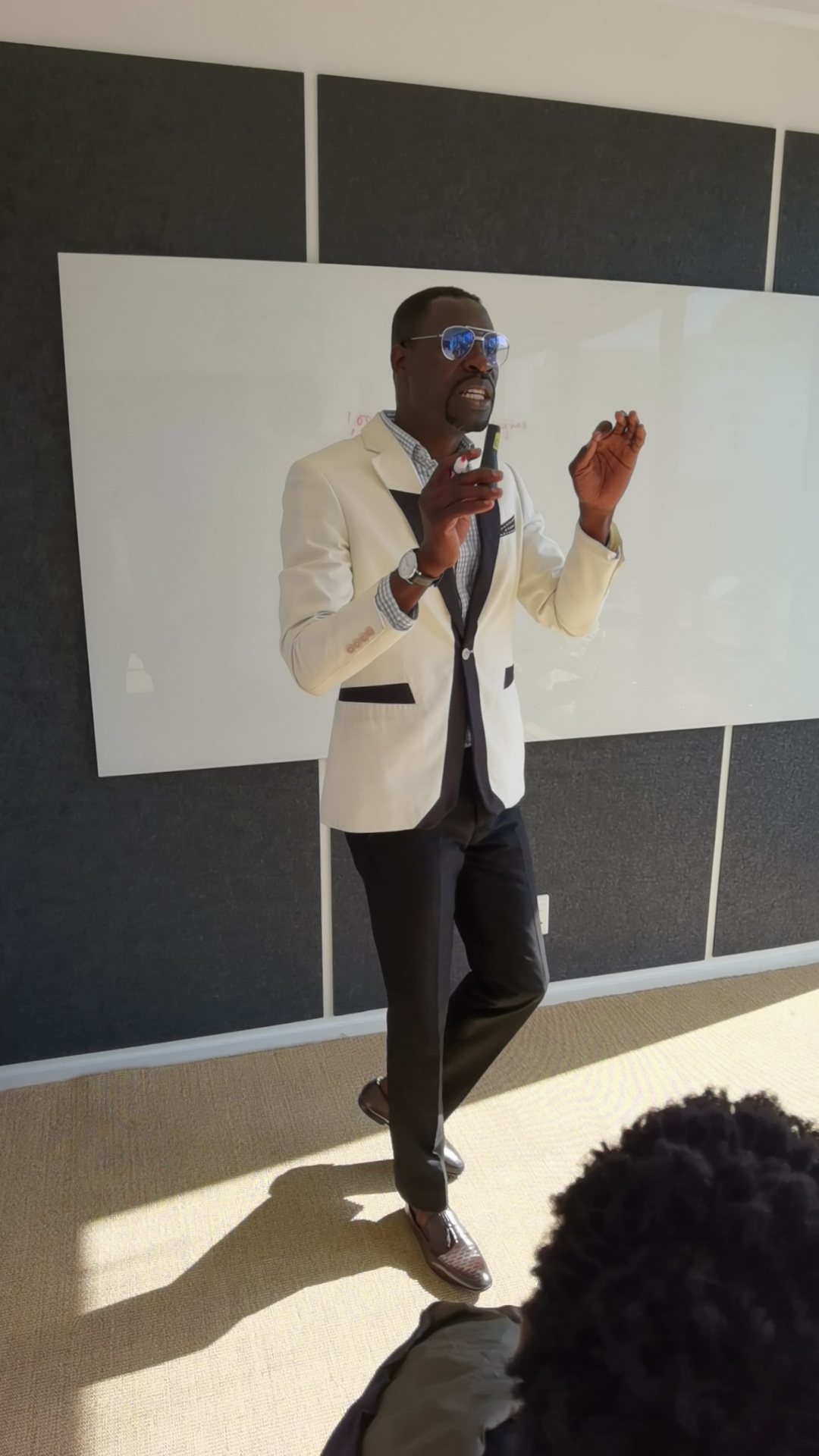 Daniel Cole teaching in front of a whiteboard